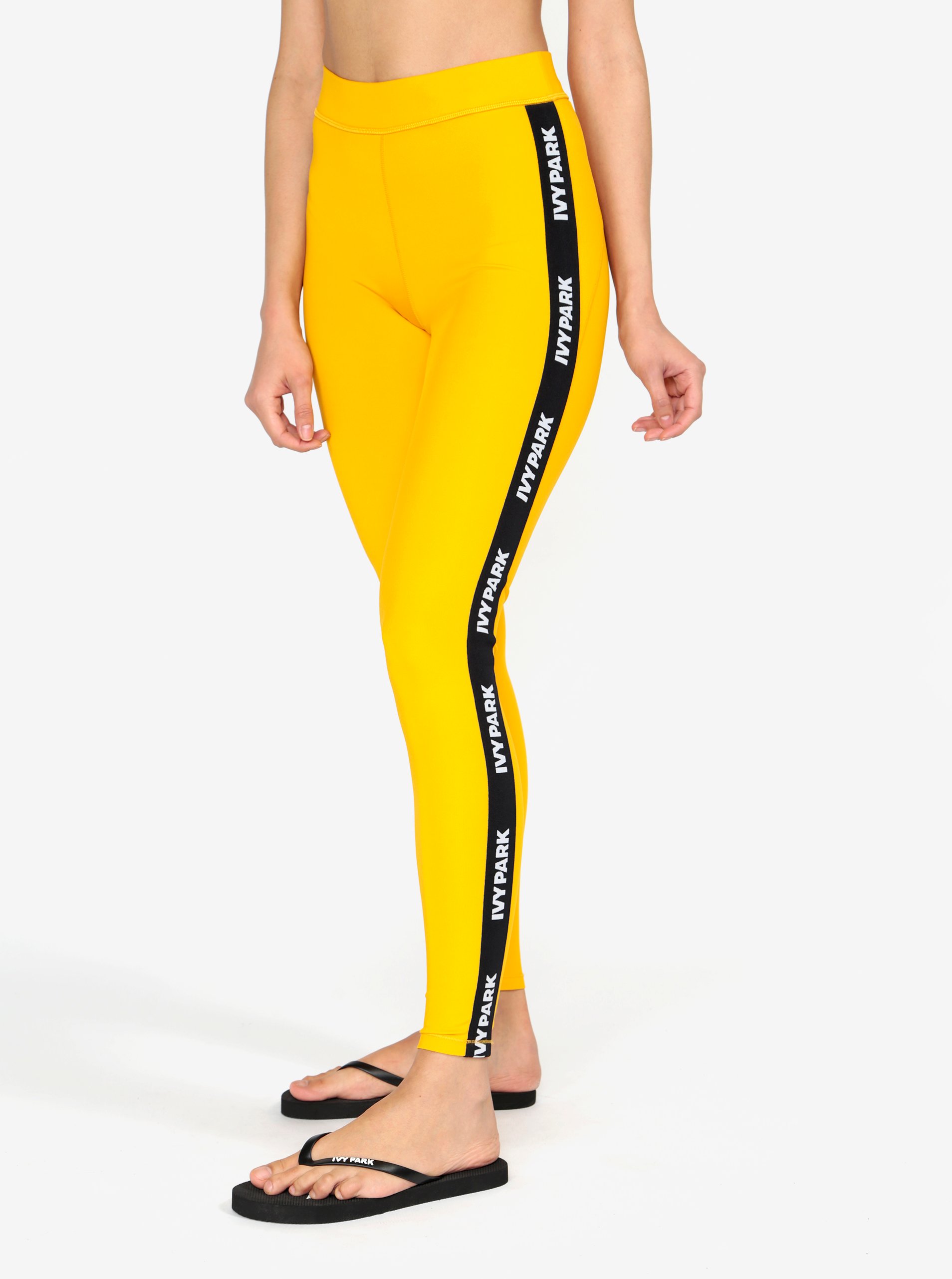 Žluté legíny s černým pruhem na nohavicích Ivy Park