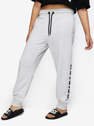 Světle šedé žíhané tepláky s potiskem na nohavici Ivy Park